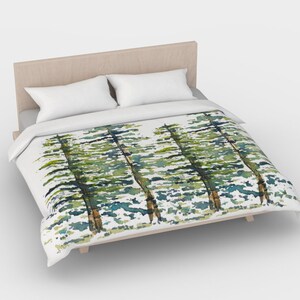 May include: A white duvet cover with a watercolor print of green trees on a white background.