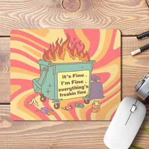 May include: A mouse mat with a retro-style design featuring a burning bin with the text "it's Fine. I'm Fine. everything's freakin fine."