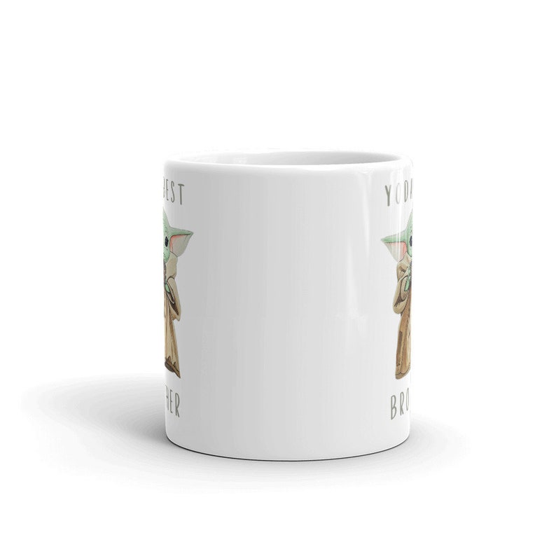 May include: White ceramic mug with a green alien character on each side. The text on the mug reads "You're my best other" and "You're my best bro".