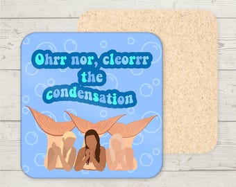 May include: A blue and white coaster with three mermaids with the text "Oh, nor, cleorr the condensation" in a retro font.