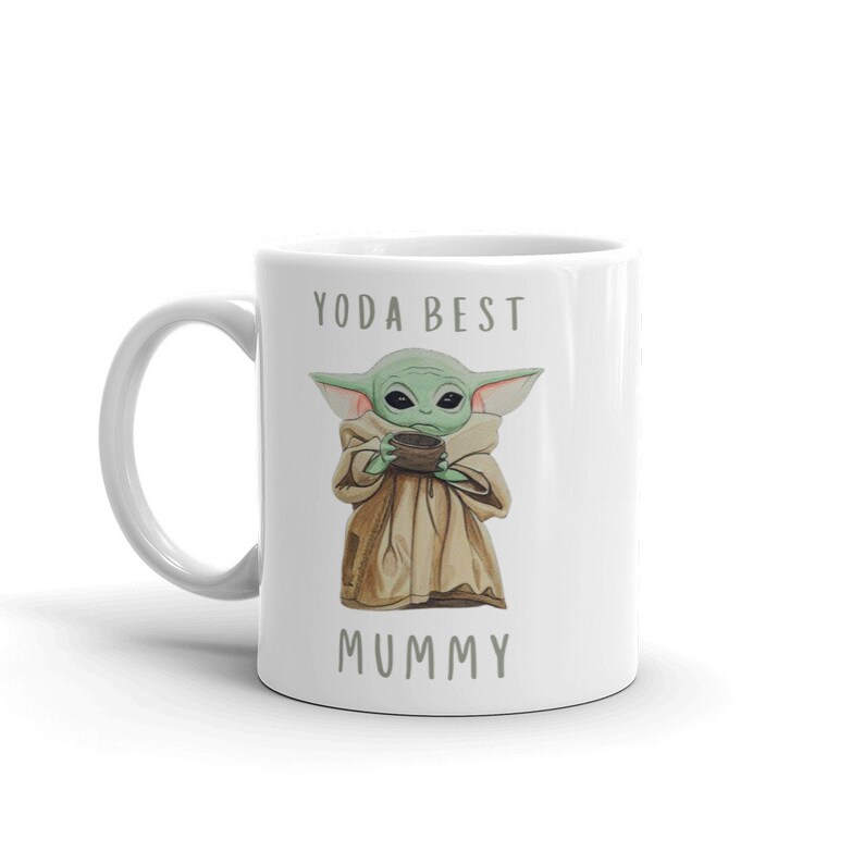 May include: White ceramic mug with a green character holding a bowl, the text "YODA BEST MUMMY" is printed on the mug.