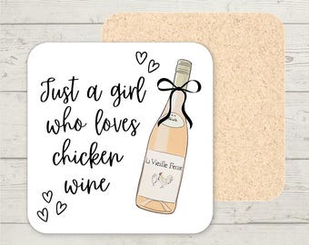 May include: Square white coaster with the text "Just a girl who loves chicken wine" in black script. A wine bottle illustration with a black bow is on the coaster. The coaster is paired with a tan cork coaster.