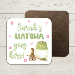 May include: White square coaster with the text "Sarah's Matcha goes here!" in green and pink lettering. A watercolour illustration of a glass of matcha latte with a bamboo whisk and a spoon with matcha powder is in the bottom right corner.