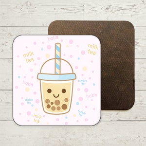 Può includere: Un sottobicchiere quadrato rosa e bianco con un'illustrazione di cartone animato di una tazza di tè boba con una cannuccia. La tazza ha una faccia felice ed è piena di perle di boba marroni. Lo sfondo è rosa con pois bianchi e le parole "boba", "tè al latte" e "tè alle bolle" scritte in azzurro.