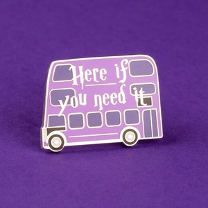 May include: Purple enamel pin shaped like a double-decker bus with the text "Here if you need it".