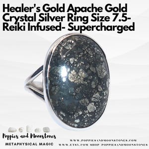 May include: A silver ring featuring a large, oval Apache Gold stone. The stone is a dark grey with silver flecks. The ring is size 7.5. The text "Healer's Gold Apache Gold Crystal Silver Ring Size 7.5- Reiki Infused- Supercharged" is above the ring. The text "Poppies and Moonstones METAPHYSICAL MAGIC WWW.POPPIESANDMOONSTONES.COM WWW.ETSY.COM SHOP POPPIESANDMOONSTONES" is below the ring.
