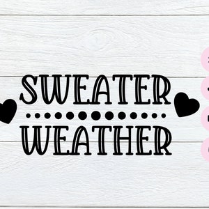 May include: Black and white graphic design with the text "SWEATER WEATHER" with two hearts on either side of the text.