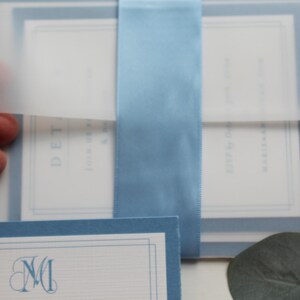 The vellum wrap adds such a touch of sophistication and softness along and also adds a protective functionality as well. Tie it all together with "something blue" in a wide light blue satin ribbon and you have a winning invitation every time.