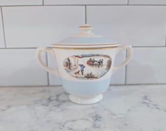 vintage Homer Laughlin China Company sugar bowl with lid, featuring the iconic "Currier & Ives" winter scene decal.