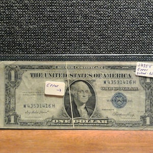 Ein Dollar-Silberzertifikat der USA von 1935 mit einem gefalteten Rinnsteinfehler