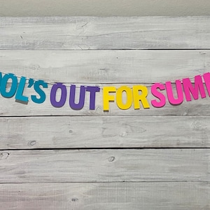 May include: A colourful paper banner with the text "SCHOOL'S OUT FOR SUMMER" hanging on a whitewashed wood background.