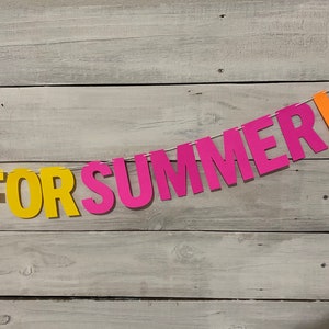 May include: A colourful paper banner with the words "Get For Summer!" in purple, yellow, pink and orange letters.