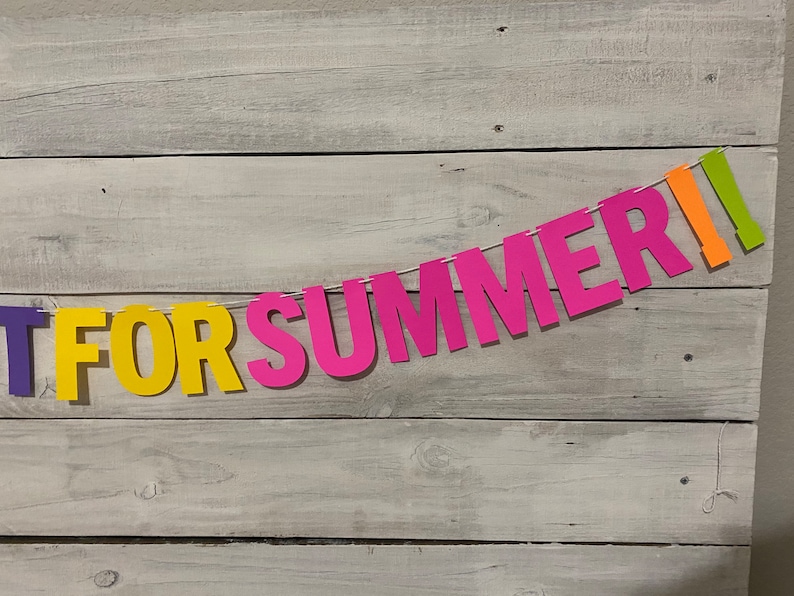 May include: A colourful paper banner with the words "Get For Summer!" in purple, yellow, pink and orange letters.