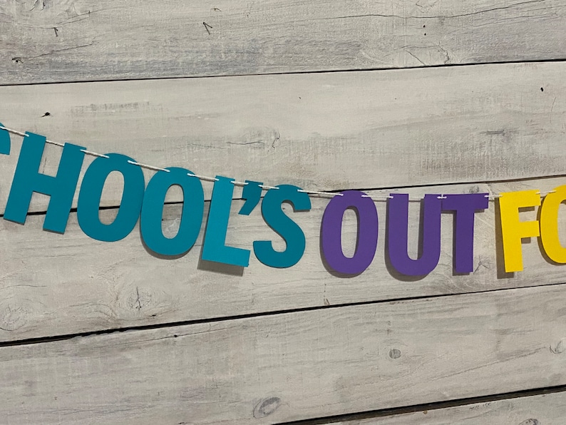 May include: A colourful banner with the text "School's Out For" in blue, purple and yellow letters.