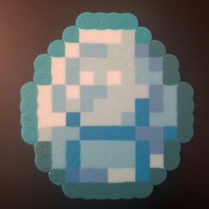 May include: A blue and white pixel art design made with perler beads. The design is a square with a blue and white pattern.