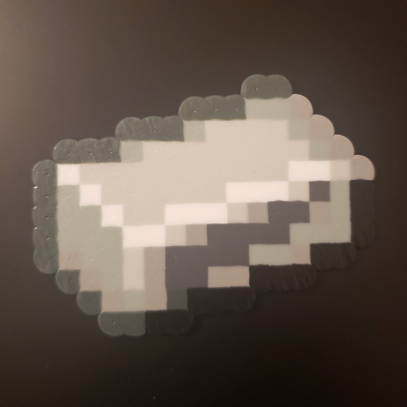 May include: A gray and white pixel art design of a gun made with perler beads.