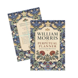 May include: Two William Morris perpetual planners featuring a dark blue background with intricate floral and bird patterns. The front cover displays the text William Morris Perpetual Planner Arts & Crafts Movement with red flowers and cream-colored accents.