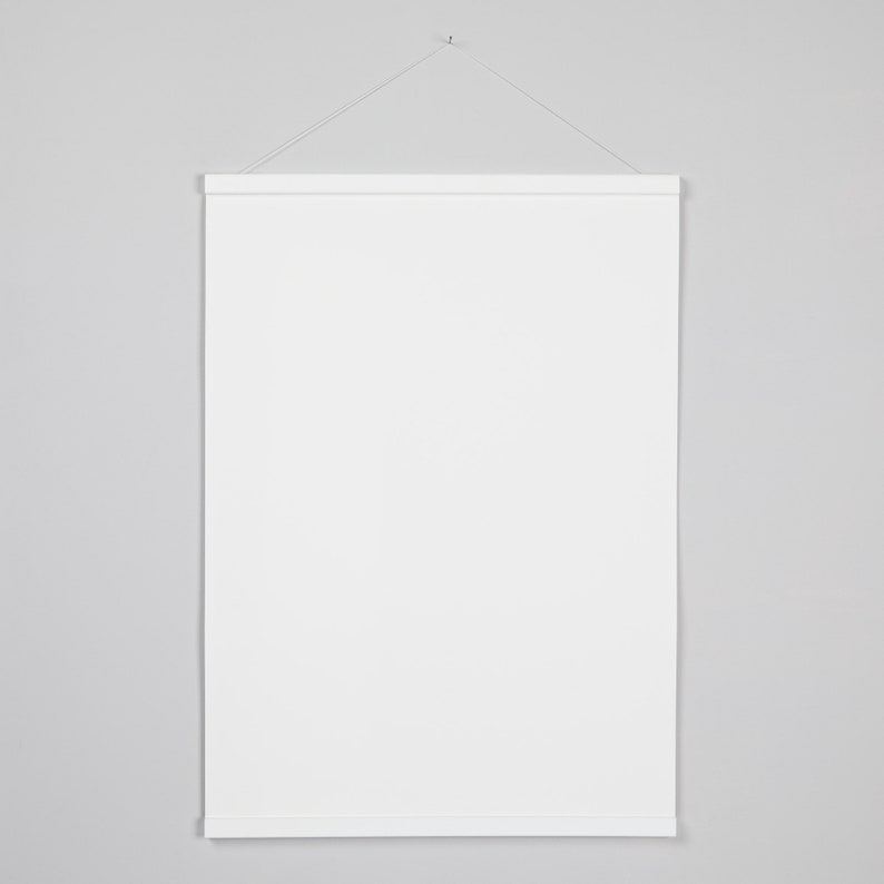 May include: A white poster frame with a string hanging from a hook on a white wall.