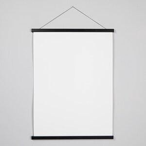 May include: A black poster hanger with a white canvas. The hanger has a black string attached to the top for hanging.