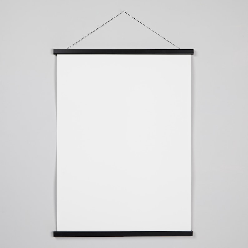 May include: A black poster hanger with a white canvas. The hanger has a black string attached to the top for hanging.