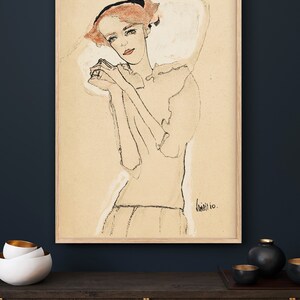 May include: A black and white line drawing of a woman with red hair wearing a white dress. The drawing is on a beige background and is signed "Klimt 10."