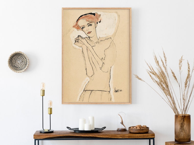 May include: A framed black and white line drawing of a woman with red hair, wearing a white dress. The drawing is on a beige background and is signed "Klee 10".