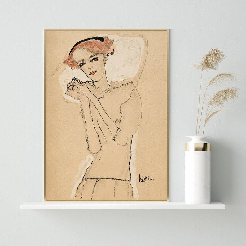 May include: A black and white line drawing of a woman with red hair wearing a white dress. The drawing is on a beige background and signed "Kall" in the bottom right corner.
