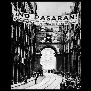 May include: Black and white photograph of a street scene with a banner reading "¡NO PASARAN!" above an archway. The banner also includes text in Spanish. People are walking on the street.