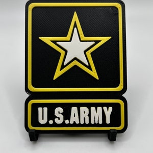 Puede incluir: Un letrero impreso en 3D negro y amarillo con una estrella blanca y el texto "U.S. ARMY".