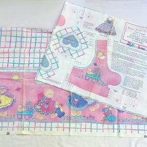 May include: Pink fabric panels with a repeating pattern of teddy bears, flowers, and a grid design. One panel has a printed pattern for a dress and the text "Purr-fect Friends". The fabric is suitable for quilting or sewing projects.