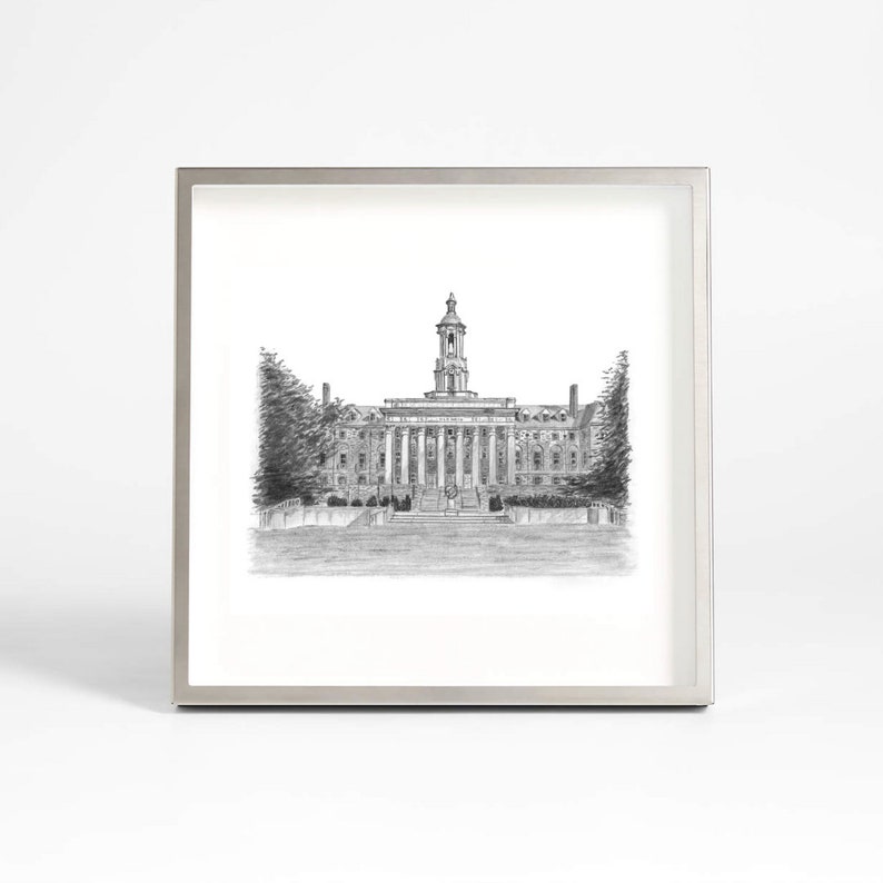 May include: A black and white pencil drawing of a large building with a clock tower. The building has a symmetrical design with multiple windows and columns. The drawing is framed in a silver frame.