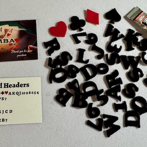 May include: A collection of playing card-themed craft supplies. Includes black felt letters, playing card suit shapes, a tube of B-7000 glue, and two cards with the word "SAMBA" printed on them. One card says "Thank you for your purchase".