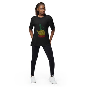 May include: A black t-shirt with a green, yellow, and red graphic of a traditional Ethiopian coffee pot. The graphic is made up of words related to coffee and Ethiopia.