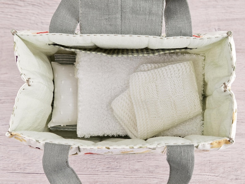 Top view of dollhouse bag interior with doll bedding and storage pocket, sewing pattern PDF