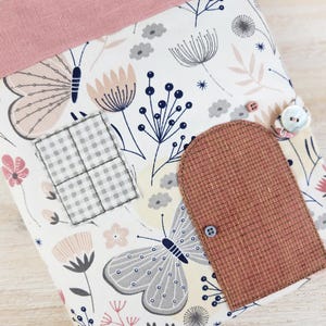 Close-up of fabric dollhouse door and window, decorative details of soft toy house