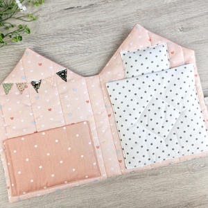 Close-up of quilted fabric dollhouse interior, bunting decoration and storage pocket