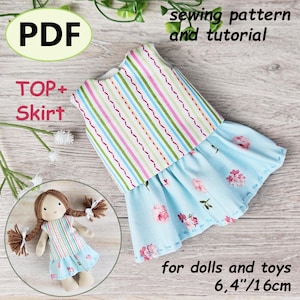 Op de afbeelding: Een naaipatroon en tutorial voor een poppen top en rok. De top heeft verticale strepen in roze, groen en blauw. De rok is lichtblauw met roze bloemmotieven. De tekst "PDF", "TOP + Skirt" en "voor poppen en speelgoed 16cm" zijn zichtbaar.