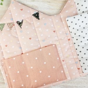 Close-up of doll bedding inside fabric dollhouse, soft pillow and blanket for dolls