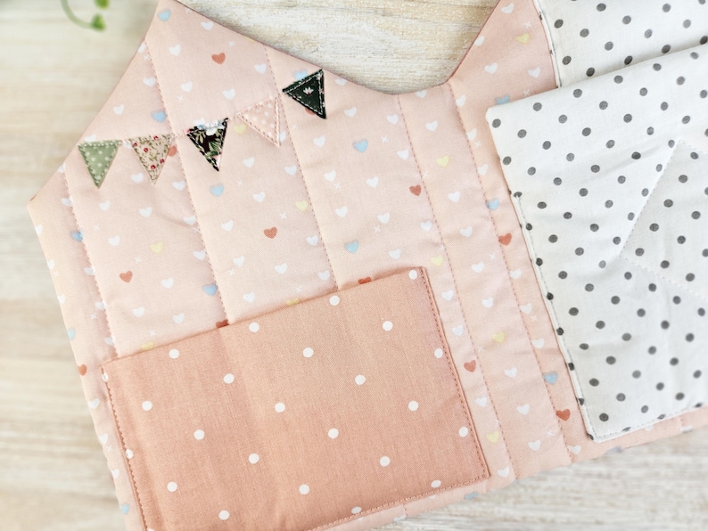 Close-up of doll bedding inside fabric dollhouse, soft pillow and blanket for dolls