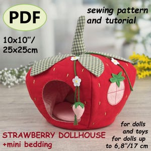 May include: A red strawberry dollhouse with green accents, white flowers, and a pink interior. The dollhouse is 10x10 inches (25x25cm) and includes mini bedding. The image also includes the text "PDF", "sewing pattern and tutorial", and "for dolls and toys".