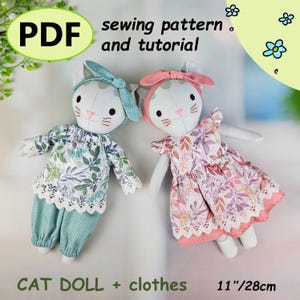 Könnte beinhalten: Zwei handgefertigte Katzendolls mit Kleidung. Eine Puppe trägt ein blaues Outfit mit Blumenmuster, die andere ein rosa Kleid mit Blumenmuster. Beide Puppen haben weiße Körper, Katzenohren und passende Stirnbänder. Der Text "PDF sewing pattern and tutorial" und "CAT DOLL + clothes 28cm".