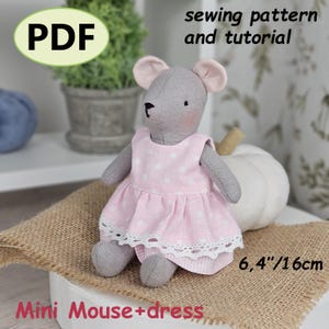 May include: A handmade grey mouse doll wearing a pink polka dot dress with white lace trim. The doll is approximately 16 cm tall. The image includes the text "PDF" and "Mini Mouse + dress". The text "sewing pattern and tutorial" is also visible.