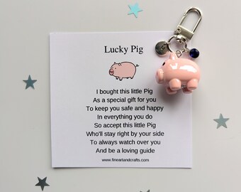 May include: A pink pig keychain with a poem that reads "I bought this little Pig As a special gift for you To keep you safe and happy In everything you do So accept this little Pig Who'll stay right by your side To always watch over you And be a loving guide www.fineartandcrafts.com"