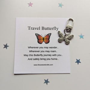 May include: A silver travel butterfly keychain with a small card that reads "Travel Butterfly" and a poem about safe travels. The card has a small orange and black butterfly illustration.