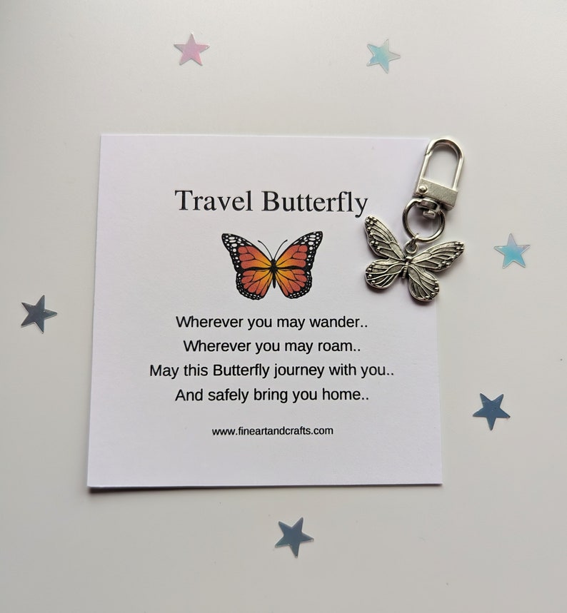 May include: A silver travel butterfly keychain with a small card that reads "Travel Butterfly" and a poem about safe travels. The card has a small orange and black butterfly illustration.