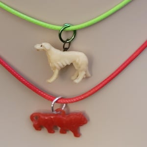 Two, Cracker Jack Charm Necklaces.
