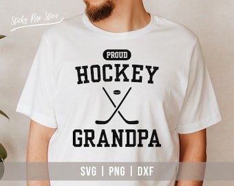 May include: White t-shirt with black text that reads "Proud Hockey Grandpa" with a hockey stick and puck graphic.