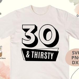 May include: Cream-colored t-shirt with a black graphic. The graphic features the number "30" above the words "& THIRSTY" in a black banner. The shirt also has "SVG PNG DXF" text.