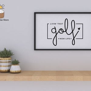 May include: Black and white framed print with the text "Livin' that golf Mom Life" in a cursive font.