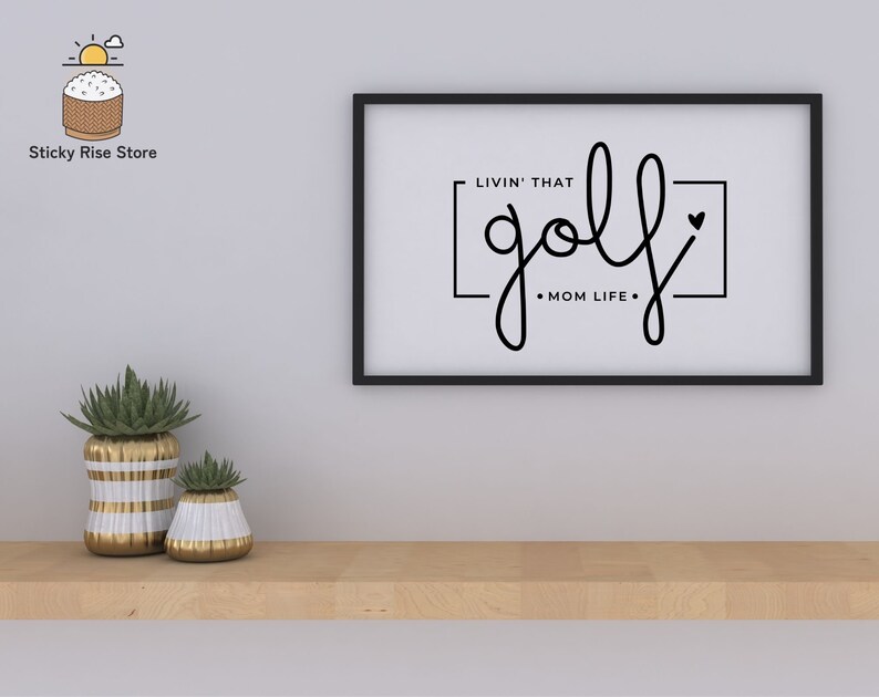 May include: Black and white framed print with the text "Livin' that golf Mom Life" in a cursive font.